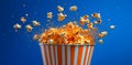 A striped container bursts open, unleashing a whimsical display of exploding popcorn kernels