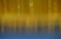 Striped curtain in shades of beige and gold with effect of reflection in water. Abstract background.