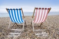 Striped deckchairs on pebble beach