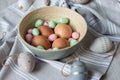 Striped and dotted easter decorative and natural eggs on pastel texture