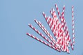 Striped and dotted paper drinking straws on light blue background top view Royalty Free Stock Photo