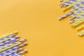 Striped drink straws of different colors in row isolated on yellow background. Minimalism concept. Pop art style. Flat Royalty Free Stock Photo