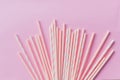 Striped drink straws of different colors in row isolated on yellow background. Minimalism concept. Pop art style. Flat Royalty Free Stock Photo