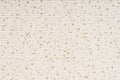 Striped embossed beige paper. Colored paper with gold dots texture background.