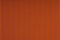 Striped embossed orange paper. Colored paper texture background