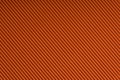 Striped embossed orange paper. Colored paper texture background