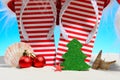 Striped flip-flops and Santa hat on tropical beach Royalty Free Stock Photo