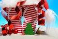 Striped flip-flops and Santa hat on tropical beach Royalty Free Stock Photo