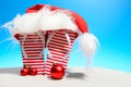 Striped flip-flops and Santa hat on tropical beach Royalty Free Stock Photo