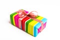 Striped gift box with pink ribbon on a white background Royalty Free Stock Photo