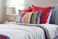 Striped headboard with Colourfull pillows and striped pillow on white bed Royalty Free Stock Photo