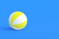 Striped inflatable beach ball on blue background. Recreation on sea or pool in summer. Fun game in summertime Royalty Free Stock Photo