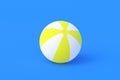 Striped inflatable beach ball on blue background. Recreation on sea or pool in summer. Fun game in summertime Royalty Free Stock Photo