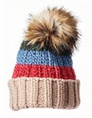 Striped Knitted Beanie Hat with Fur Pom Pom on White Background Royalty Free Stock Photo