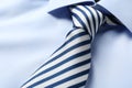 Striped male necktie on blue shirt