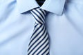 Striped male necktie on blue shirt Royalty Free Stock Photo