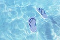 Striped marine flip flops floating in clear sea water Royalty Free Stock Photo