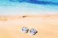 STriped marine flip flops on a sandy beach Royalty Free Stock Photo