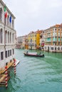 Striped mooring poles in water along the Grand Canal in Venice for boats to navigate and dock. Royalty Free Stock Photo