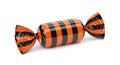 Striped orange and black wrapped candy with decorative ends Royalty Free Stock Photo