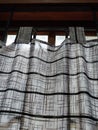 striped patterned fabric with black line silhouettes behind it