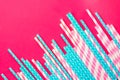 Striped pink and white blue polka dot paper drinking straws on magenta background. Kids birthday party celebration Royalty Free Stock Photo