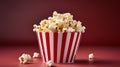 Striped popcorn box with delicious popcorn on red gradient background and spacious empty space