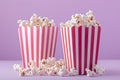 striped popcorn boxes against a delicate pink backdrop, fluffy popcorn for a sweet movie treat