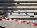 Striped red caution tape over renovation of cement steps