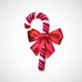 Striped Red and white Chrisrmas candy. Realistic sweet stick with silk bow. Confection for Christmas and New Year greeting cards