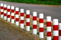 Striped red and white roadside safety posts Royalty Free Stock Photo