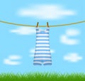 Striped retro swimsuit hanging on rope