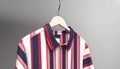 Striped shirt hanging on coathanger in modern boutique store generated by AI
