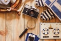 Striped slippers, camera, bag and maritime decorations on the wooden background