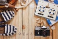 Striped slippers, camera and maritime decorations on the wooden background