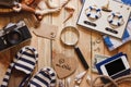 Striped slippers, camera, phone and maritime decorations on the wooden background Royalty Free Stock Photo