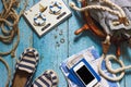Striped slippers, phone and maritime decorations on the wooden background Royalty Free Stock Photo