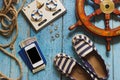 Striped slippers, phone and maritime decorations on the wooden background Royalty Free Stock Photo