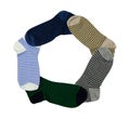 Striped socks in different colors folded in a circle on a white background