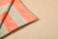 Striped soft beach towel on sand, closeup