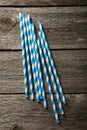 Striped straws for cocktails on a grey wooden background Royalty Free Stock Photo