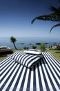 Striped Sunlounger and sunny sea views Royalty Free Stock Photo