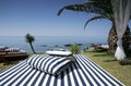 Striped Sunlounger and sunny sea views Royalty Free Stock Photo