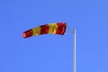 Striped Windsock against Clear Blue Sky Royalty Free Stock Photo