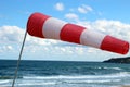 Striped windsock, next to the ocean