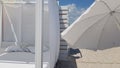 Striped wood wall with white sunshade and white textile parasol