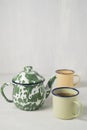 Stripes vitreous enamel teapot and tea cups with tea