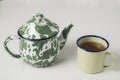 Stripes vitreous enamel teapot and tea cups with tea