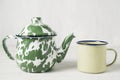 Stripes vitreous enamel teapot and tea cups with tea