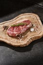 Striploin steak rustic lighting overhead, wooden board presentation Royalty Free Stock Photo